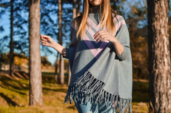 How can you style a poncho for a bohemian look?